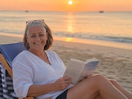 Katie Brown at the beach reading